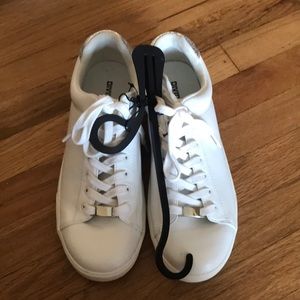 H&M white sneakers with silver trim on the back.